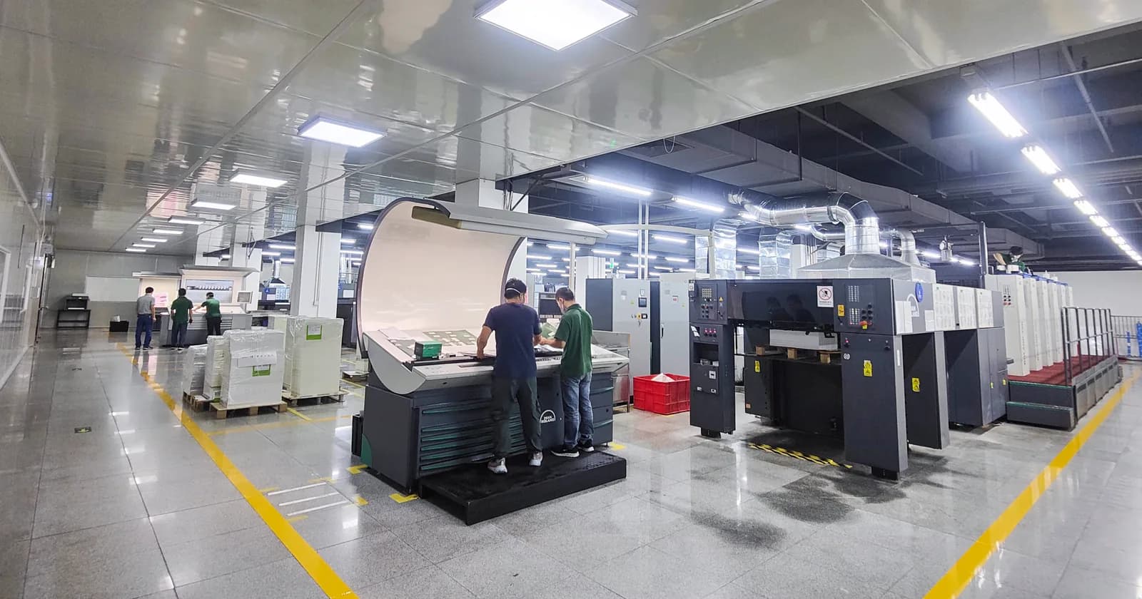 Operators reviewing printed sheets in an offset-printing production environment